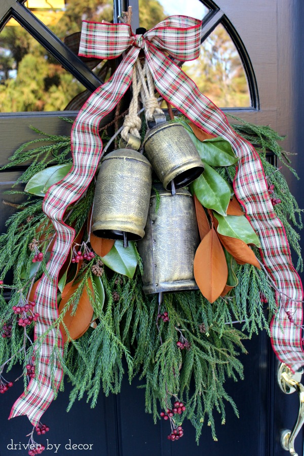 Fresh greenery and large bells - a welcoming holiday door decoration!