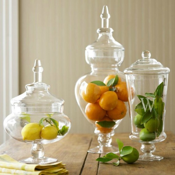 Apothecary jars filled with lemons, limes, and oranges