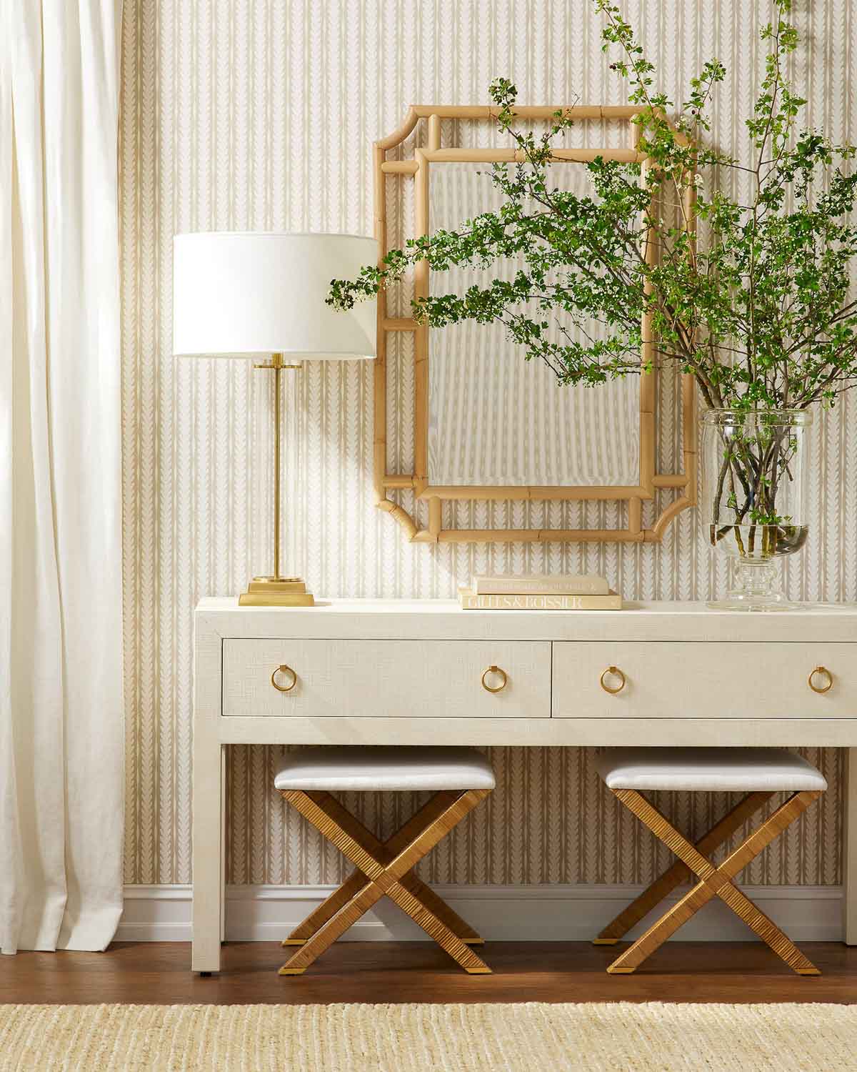 Entryway with console, lamp, mirror, and pair of X-base stools