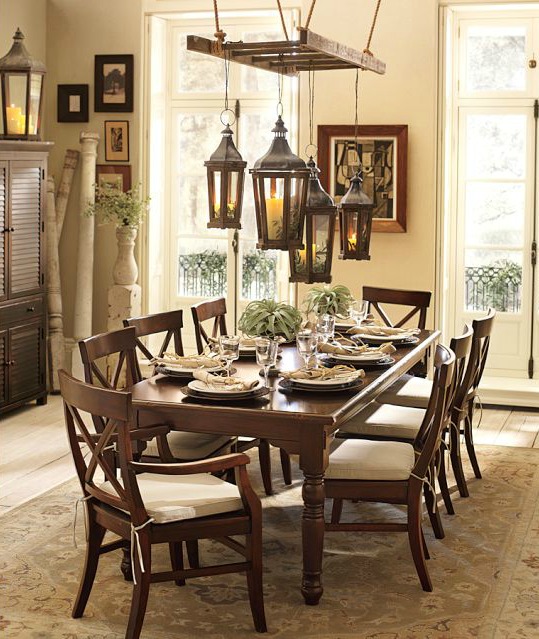 Lanterns hung from a lantern over a dining table - so gorgeous!