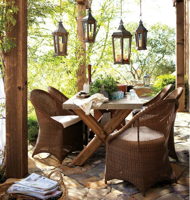 A group of lanterns hanging over an outdoor dining area - beautiful!