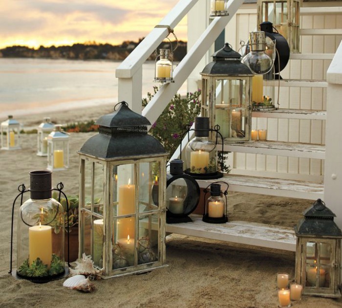 Different sized lanterns lined up along an exterior staircase - gorgeous