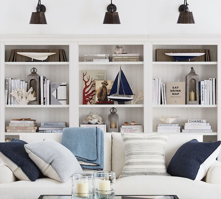 Lanterns used to decorate shelves in a living room