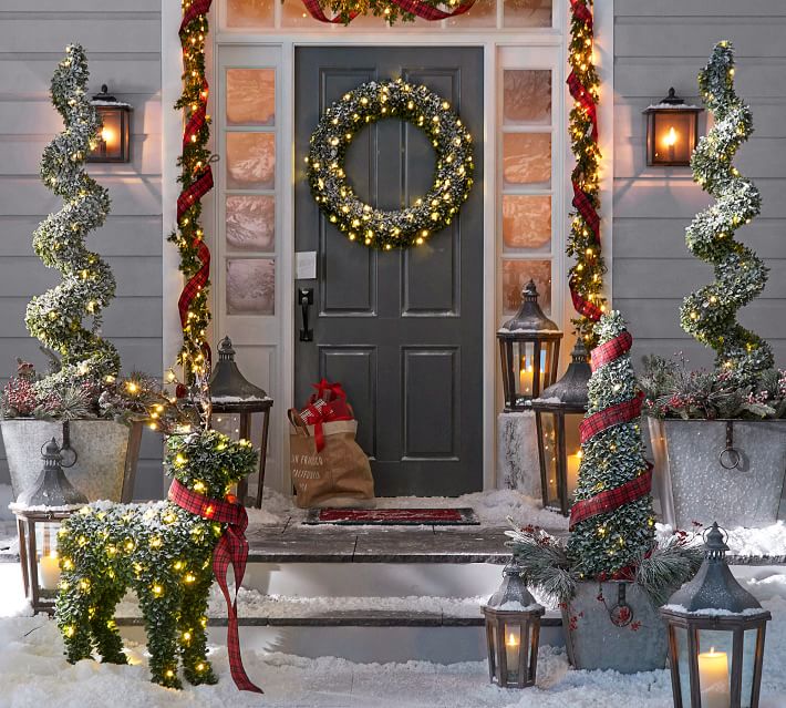 Love these gorgeous lanterns along the front walkway and stairs of this beautiful porch decorated for Christmas!