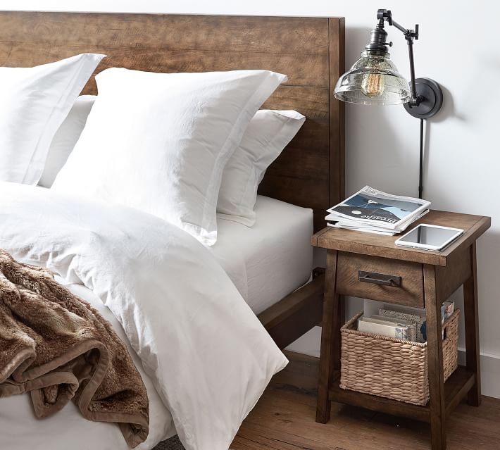 A seagrass basket on the bottom shelf on a nightstand is perfect for corralling clutter!