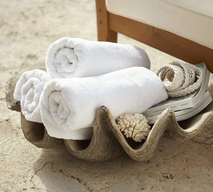 This faux giant clam shell is a stylish way to store towels by a pool or in a bathroom!