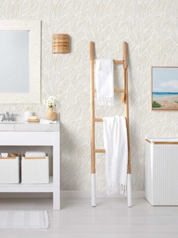 Bathroom towels draped on decorative ladder