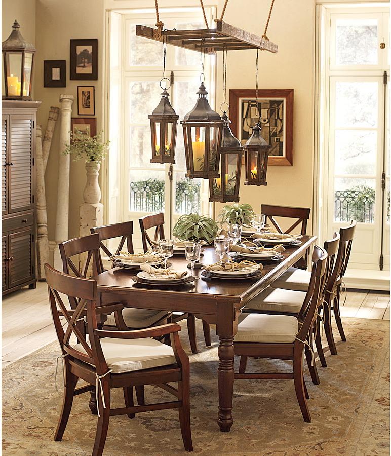 Ladder above dining table with hanging lanterns