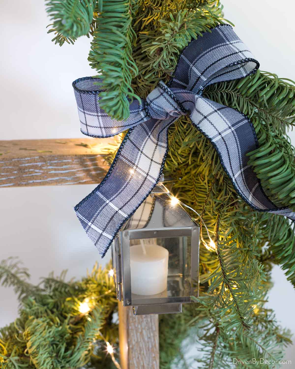 Mini lanterns tied onto a garland with ribbon