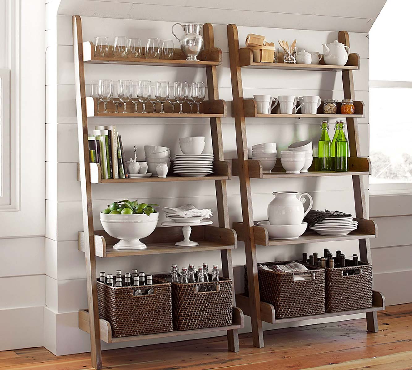 Ladder shelf with dishes, serving pieces, and other kitchenware stored on the shelves