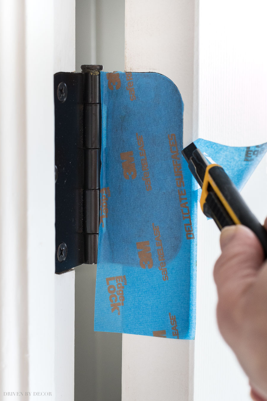 To prep your door for painting, cover hinges with painter's tape and use a razor cut away extra tape by tracing around them!