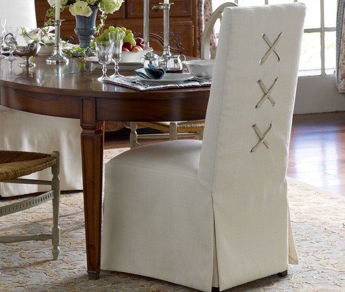 Slipcovered chairs with laced X back design