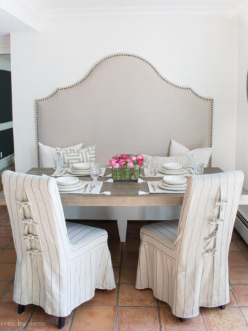 Our breakfast nook with a high backed banquette and slipcovered chairs with ties in the back!