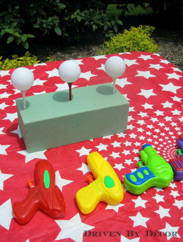 Carnival party water gun game - shoot the ping pong ball off the tees!