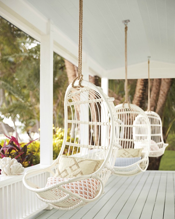 Porch lined with hanging rattan chairs - so dreamy!