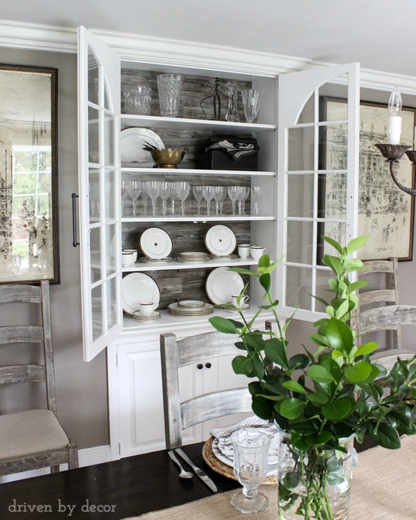 Built-in dining room china cabinet with wood backdrop and large pulls