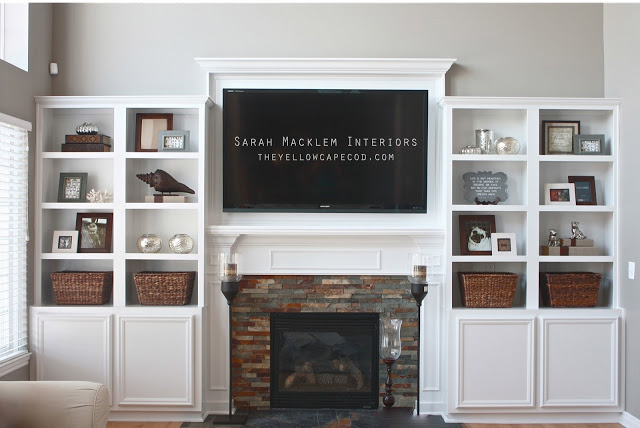 Loving the design of the TV mounted above the fireplace and bookcases on both sides!