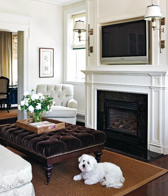 Loving how this tv over the fireplace is in a recessed niche and flanked by sconces - gorgeous!