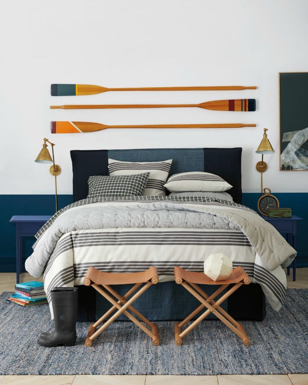 Three decorative oars hung above the bed as art