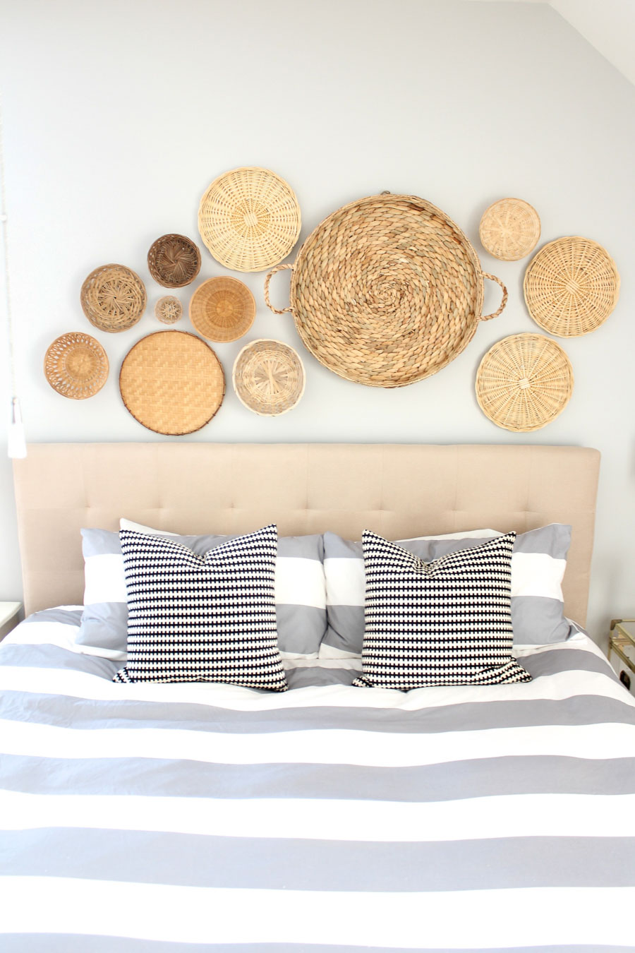 Using baskets is such a gorgeous idea for decorating the space above your bed! By Summer of Simple Stylings