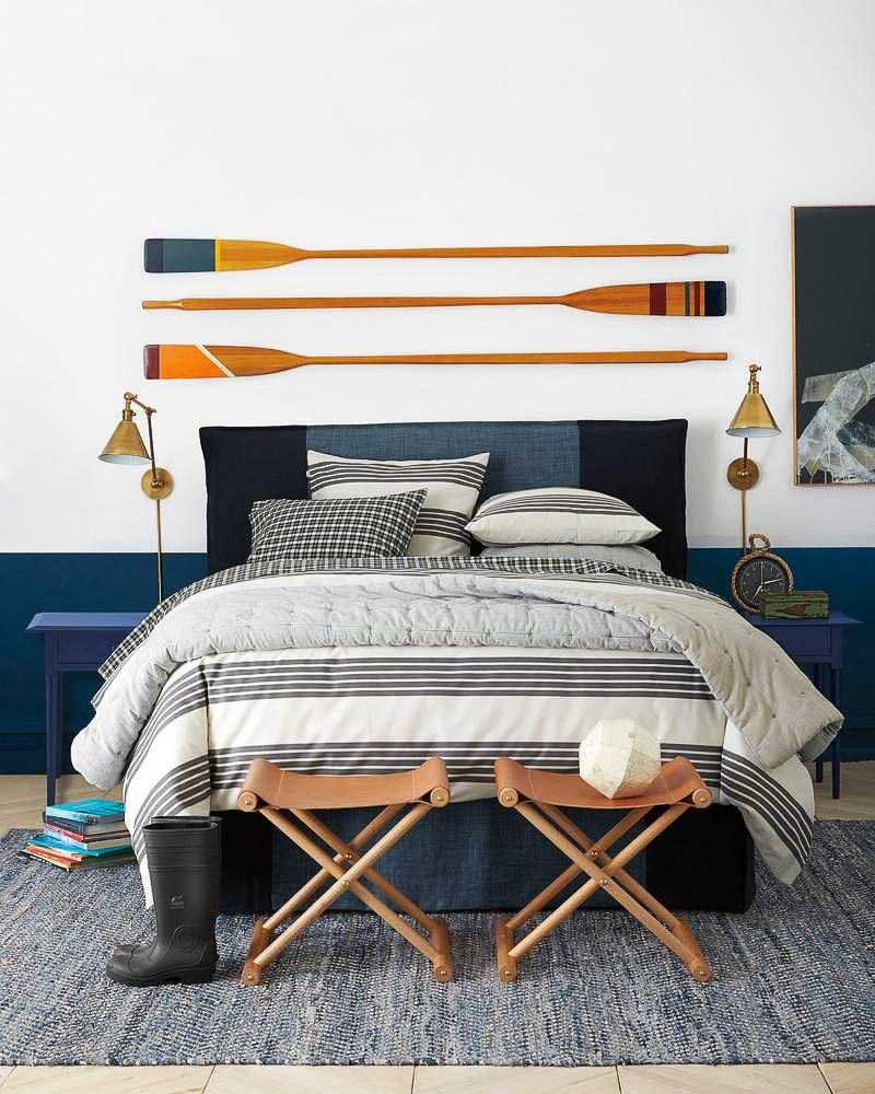 Loving the trio of colorful oars as above the bed decor!