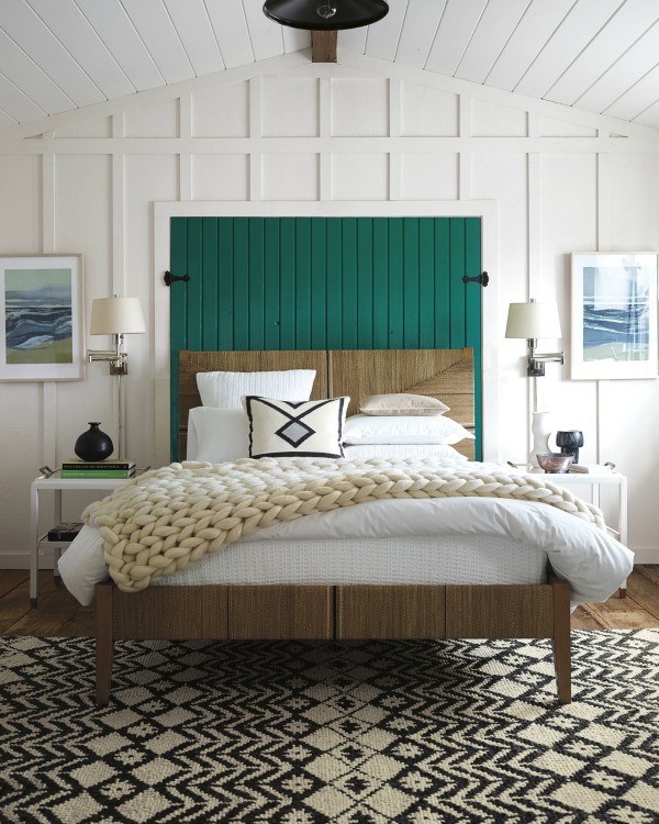 Faux shutters decorate the space above the bed