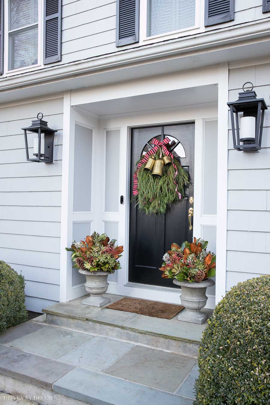 Our Christmas front porch with a DIY door swag and planters - how-to included in post!