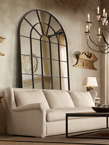 Love the look of having an oversized palladian leaner mirror behind a sofa!