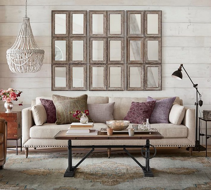 Love this fabulous arrangement of multi-paned mirrors above the sofa!