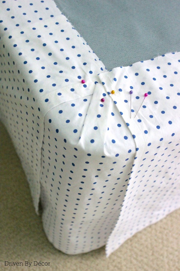 Corner of bedskirt with panels pinned to stay in place