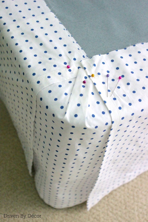 Corner of bedskirt with panels pinned to stay in place