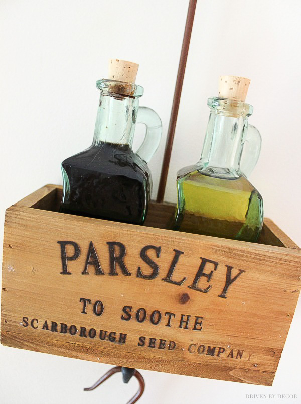 This cute hanging wooden herb box is perfect for holding tabletop essentials like oil and vinegar bottles!