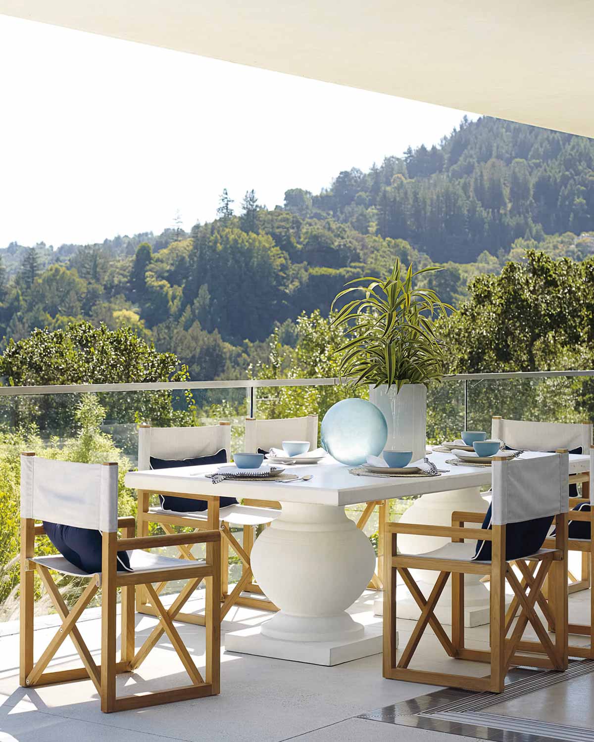 Teak director chairs around an outdoor dining table