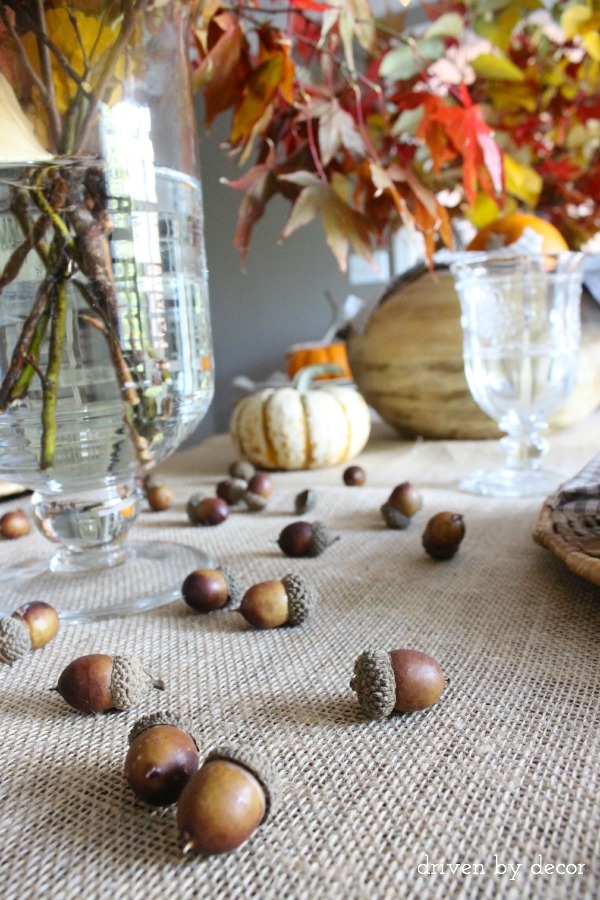 Driven by Decor - Acorns scattered across Thanksgiving table runner
