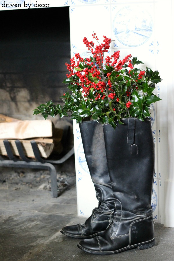 Greenery and berries in a pair of black riding boots
