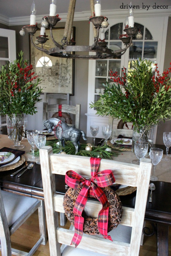 Dining room centerpieces of greenery mixed with berry branches