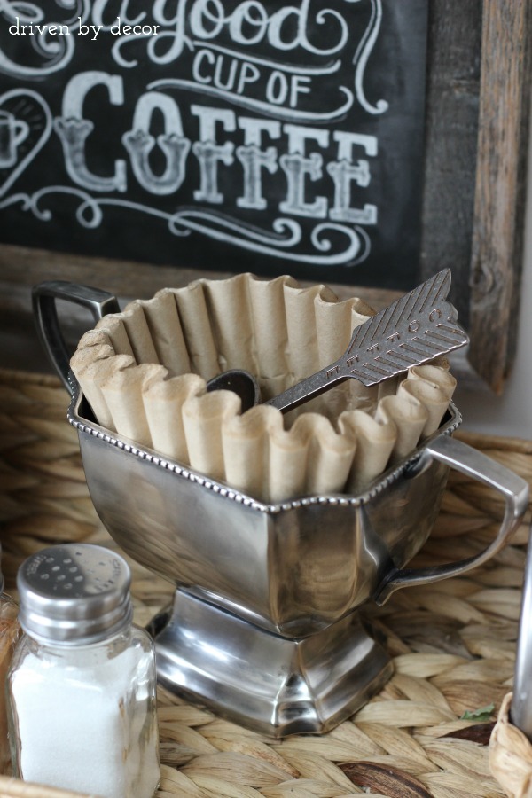 Trophy cup holds coffee filters and spoon as part of home coffee bar!