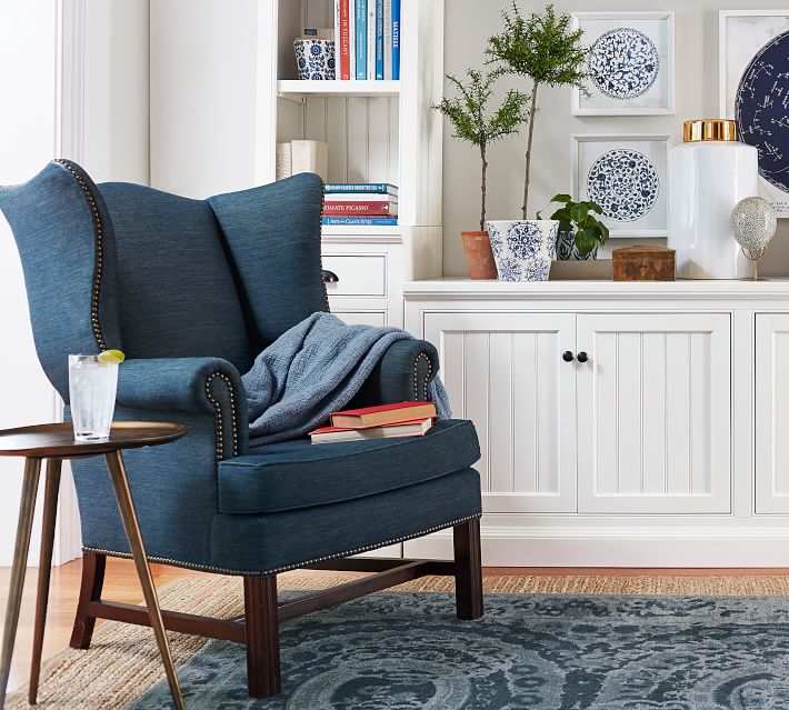 Create a cozy reading nook with a comfy chair and small side table - great way to fill and empty living room corner!