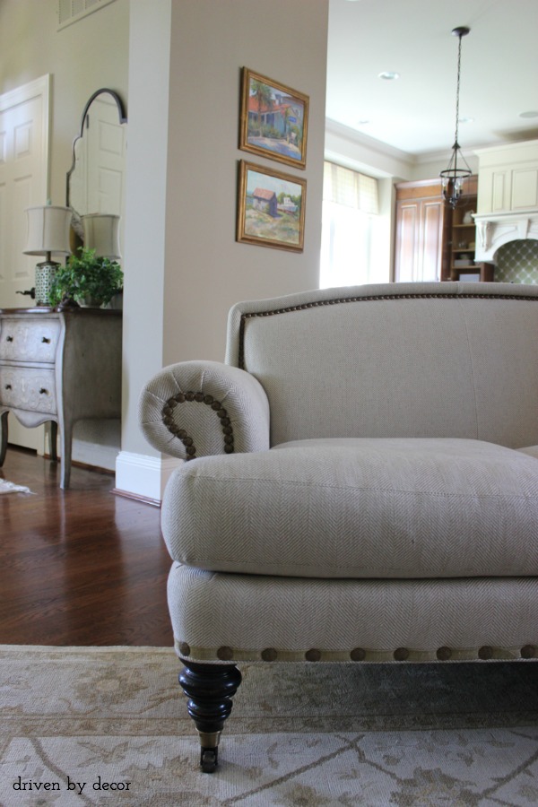 Love the nailhead trim and casters on this sofa