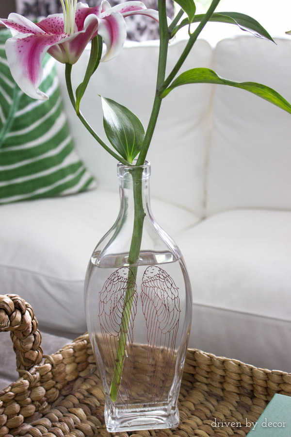 Decorative liquor bottle used as vase after using an easy trick to remove the bottle lettering