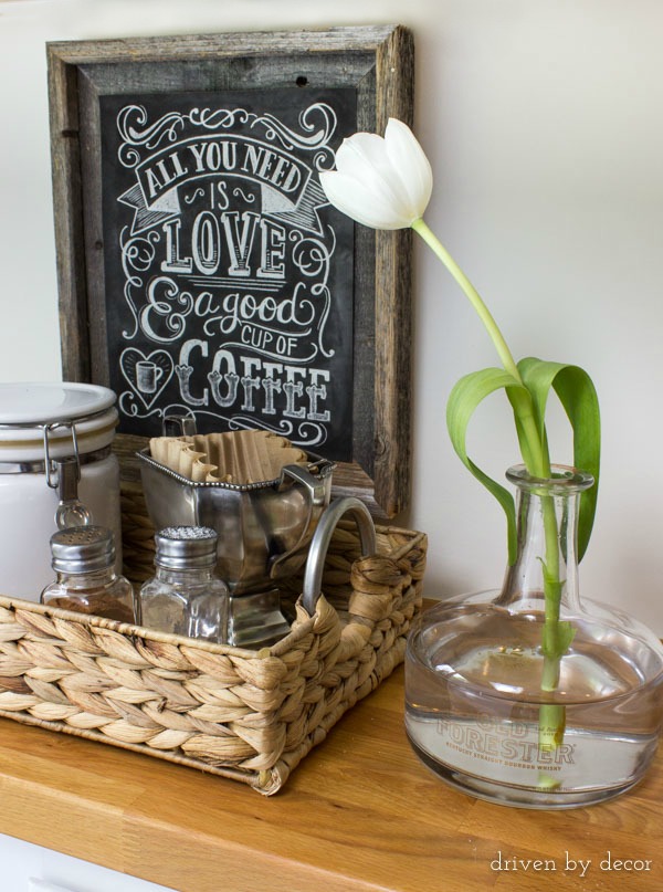 Old liquor bottle used as bud vase (next to cool kitchen coffee station!) sean