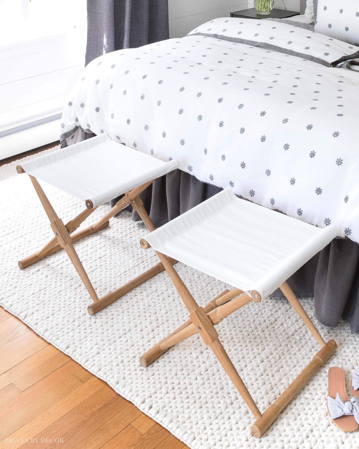 Love the look of a pair of stools at the end of the bed!