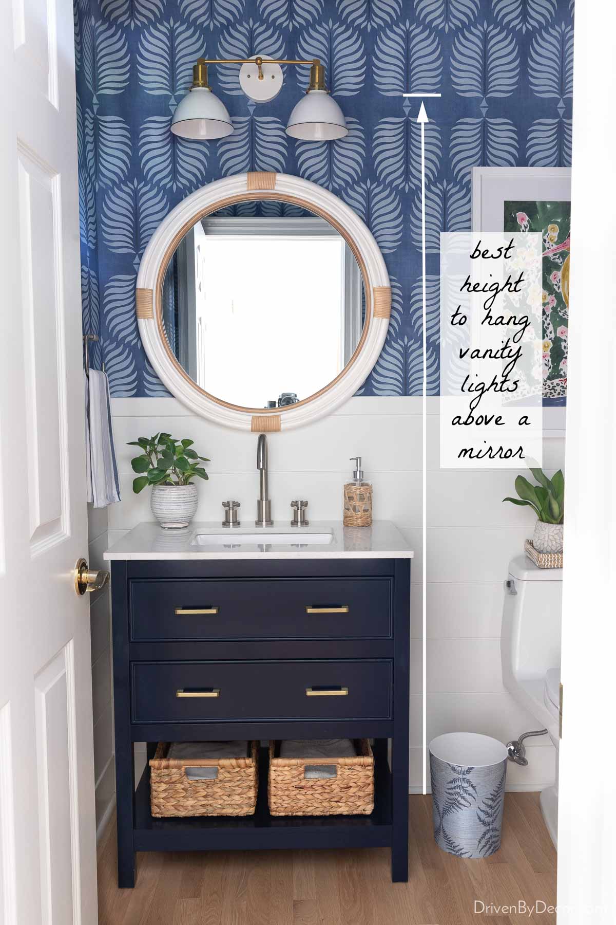 Vanity lights above round mirror and single vanity - shows how high to hang them