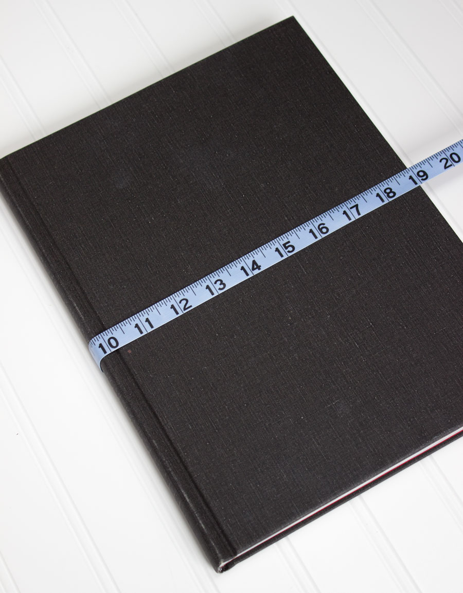 The first step to making fabric book covers is measuring