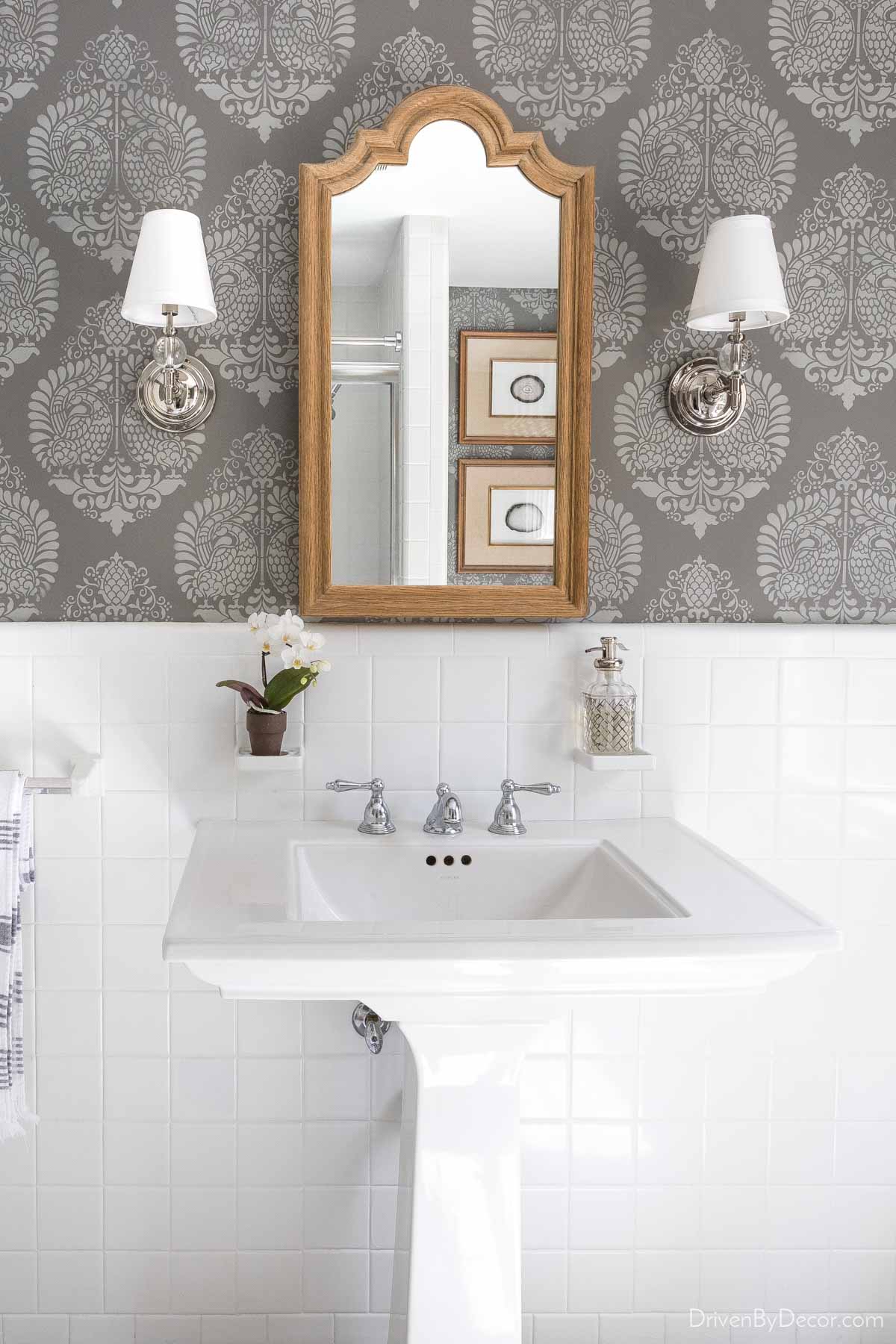 Powder room sink with wall stencils used to create wallpaper-like pattern on walls