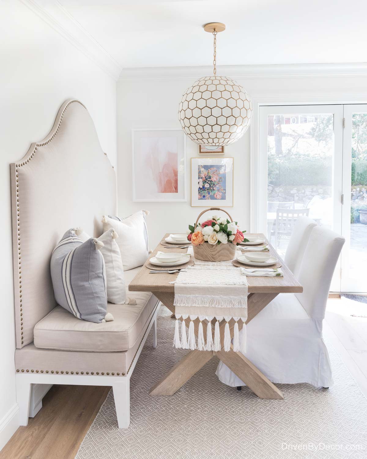 Light wood trestle table with upholstered banquette