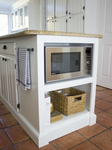 Shelving added to kitchen island to get microwave off the countertop!