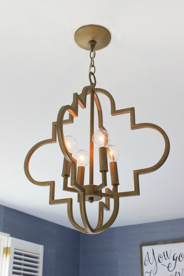 Beautiful gold arabesque chandelier - looks so cute in this bedroom!