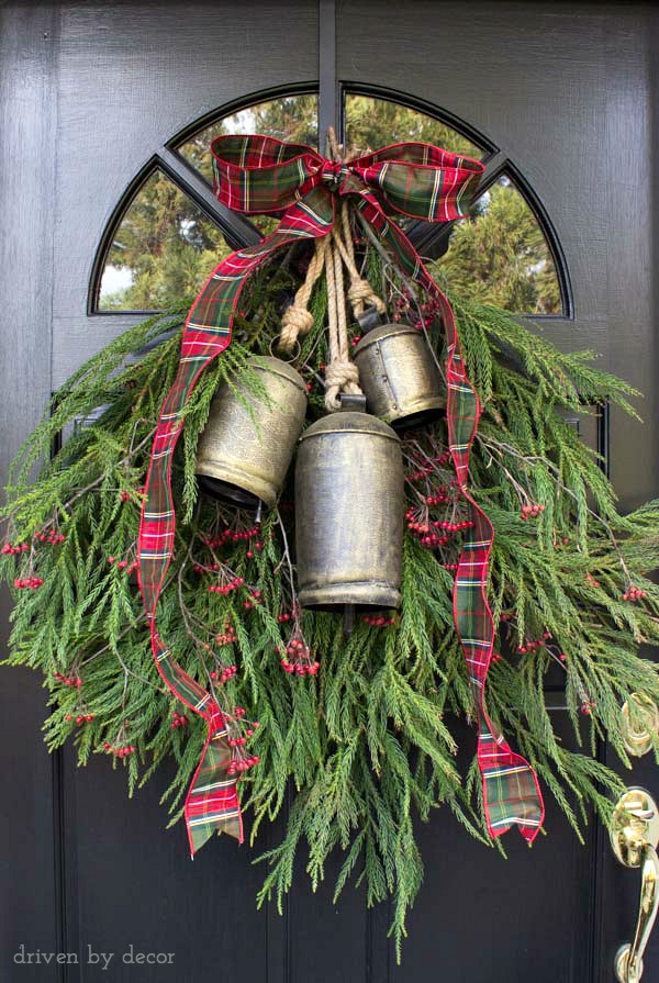 A welcoming holiday door decoration made with backyard clippings of greenery and berry branches
