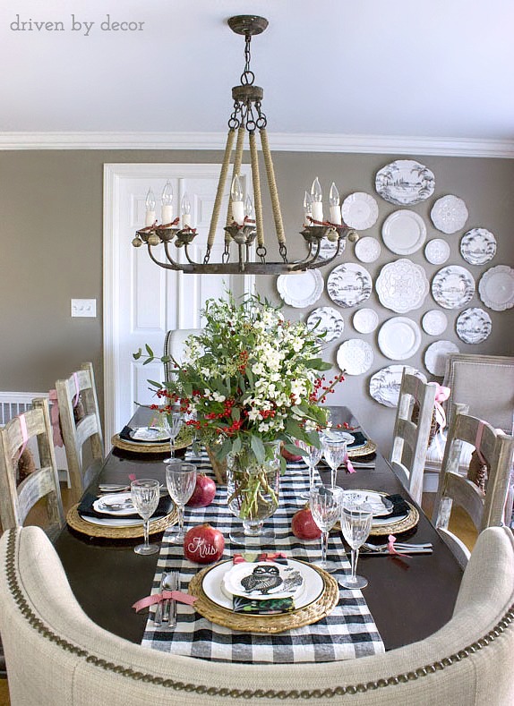 Dining room decorated for Christmas - love the black and white mixed with the green and red. And that plate wall!